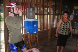 Stopping in a village in Laos to drink filtered water from a TerraClear ceramic water filter
